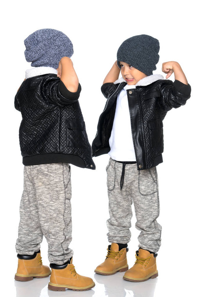 Two little boys in black jackets and hats. - Фото, зображення