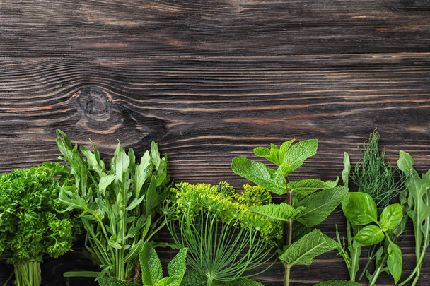 Different fresh herbs on wooden background - 写真・画像