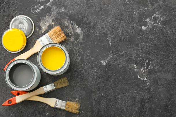 Cans of paint and brushes on grey background - Photo, Image