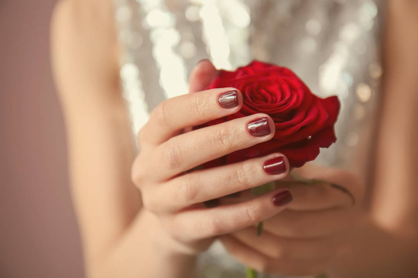 Young woman with beautiful manicure and rose, closeup - Zdjęcie, obraz