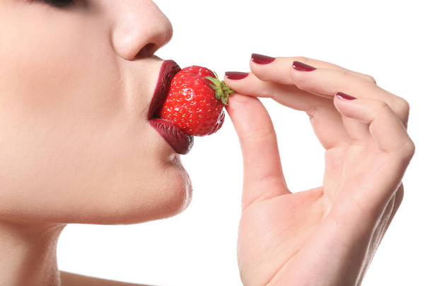 Sexy young woman with strawberry on white background, closeup - Φωτογραφία, εικόνα