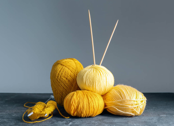 Knitting yarn with needles on grey background - Photo, Image