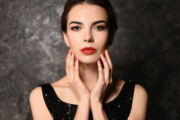 Young woman with beautiful manicure on dark background - Фото, зображення