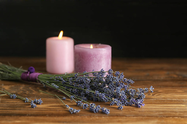 Beautiful lavender and candles on wooden table - Fotó, kép