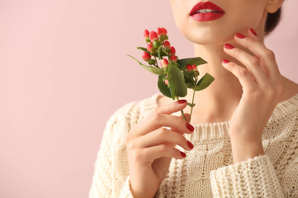 Young woman with beautiful manicure and branch on color background - Fotó, kép