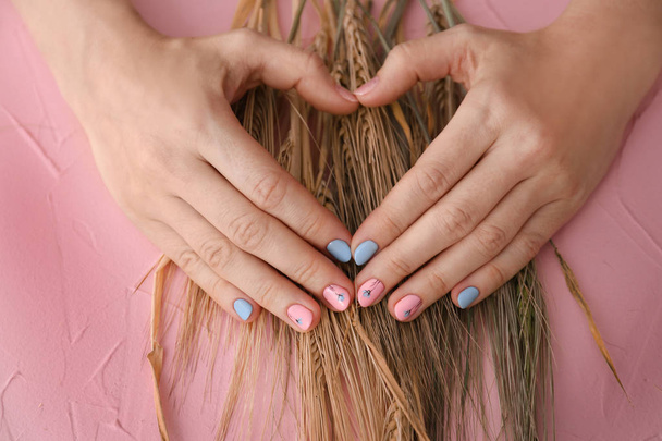 Female hands with stylish color nails on wheat ears, closeup - Photo, Image