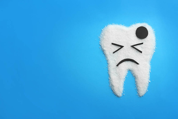 Molar tooth made of sugar on color background. Healthy teeth concept - 写真・画像