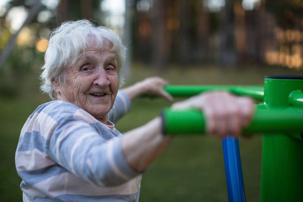 Yaşlı bir kadın sabah egzersiz sokak spor oyun yapmak.  - Fotoğraf, Görsel