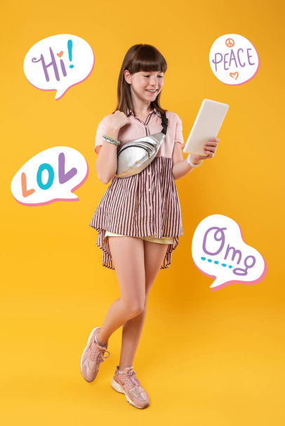 Cheerful teenager smiling while having a video call - Фото, зображення