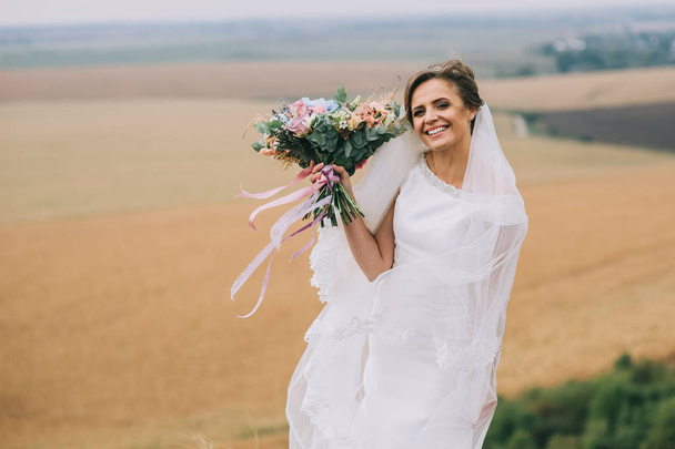 Beautiful bride outdoors  on background - Fotoğraf, Görsel