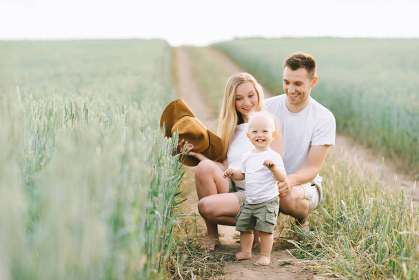young happy family have a fun with their little baby in the field - Fotoğraf, Görsel
