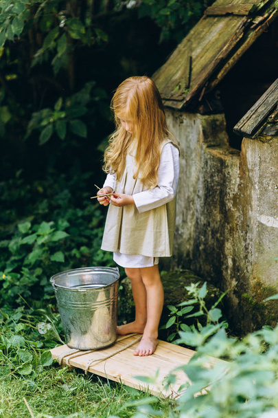cute little girl with blond hair outdoors - Fotografie, Obrázek
