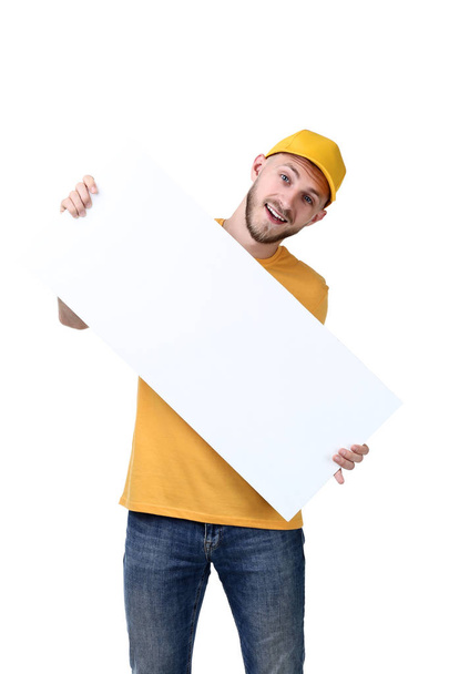 Delivery man in yellow uniform with blank board on white background - Zdjęcie, obraz