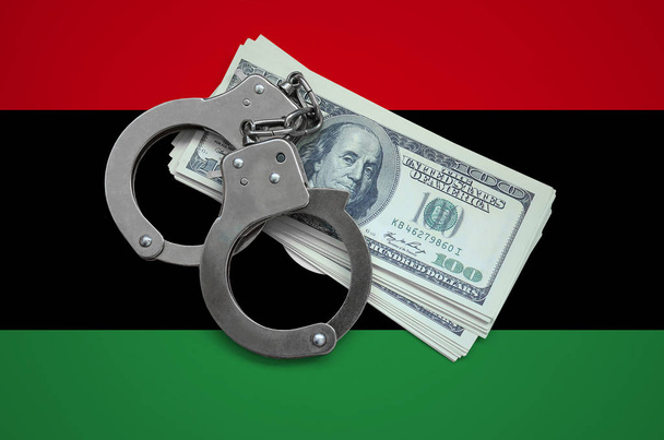 Bandera de Libia con esposas y un paquete de dólares. Corrupción de divisas en el país. Delitos financieros
. - Foto, imagen