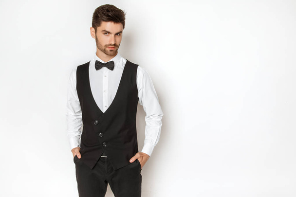 Strong commercial male model face in tuxedo on white background in studio isolaed - Fotoğraf, Görsel