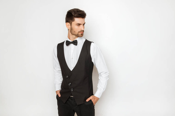 Strong commercial male model face in tuxedo on white background in studio isolaed - Fotoğraf, Görsel