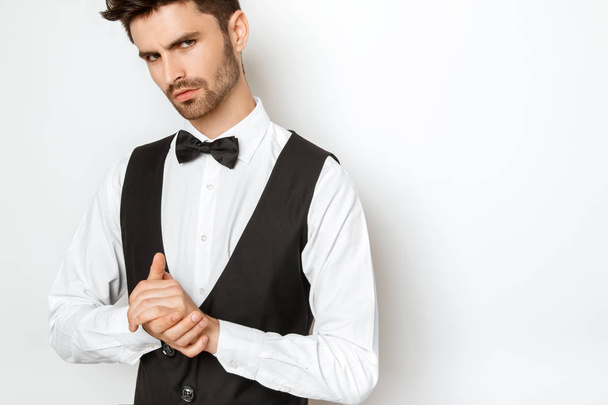 Strong commercial male model face in tuxedo on white background in studio isolaed - Fotó, kép