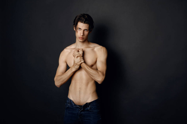 Male model in denim blue jeans on black background in studio isolated - Photo, Image