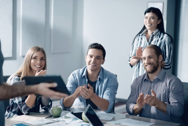 Positive young colleagues showing approval to their coworker - Foto, Bild