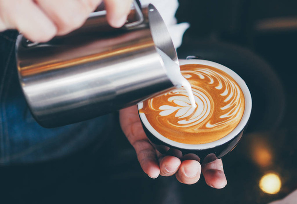 barista make coffee latte art with coffee espresso machine in coffee shop cafe in vintage color tone - Φωτογραφία, εικόνα