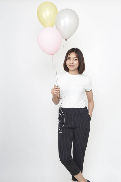 Attractive young asian woman with air balloons on white background - Zdjęcie, obraz