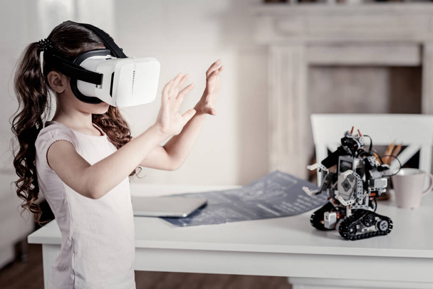 Brunette amazed girl trying to size VR picture - Fotografie, Obrázek