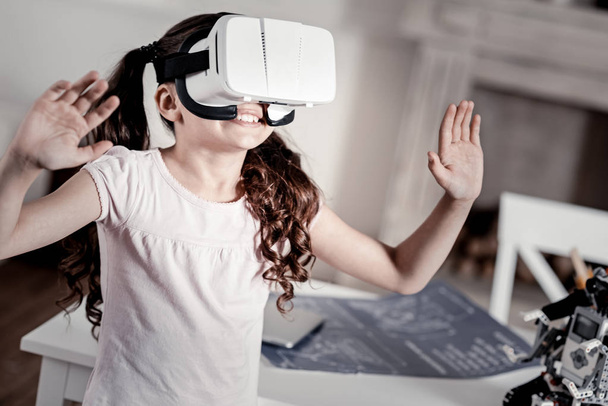 Astonished laughing girl seeing unbelievable VR image - Photo, Image