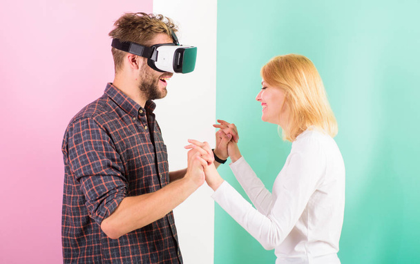 Man VR glasses enjoy video game. Best gift ever. Man enjoy virtual reality. Girl happy he like her gift. Gift ideas for men. Make him happy gift him virtual reality glasses and let play games all day - Foto, imagen