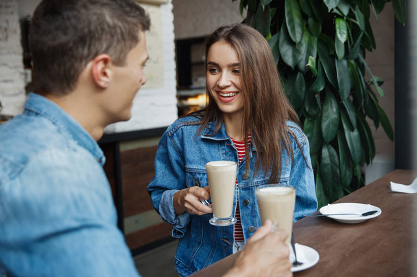 Couple With Coffee On Date. Beautiful Smiling People In Love Drinking Coffee And Talking In Cafe. Happy Young Man And Woman Enjoying Romantic Date With Coffee In Bakery. High Quality - Photo, image