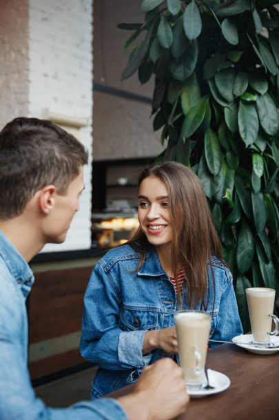 Couple With Coffee On Date. Beautiful Smiling People In Love Drinking Coffee And Talking In Cafe. Happy Young Man And Woman Enjoying Romantic Date With Coffee In Bakery. High Quality - Фото, изображение