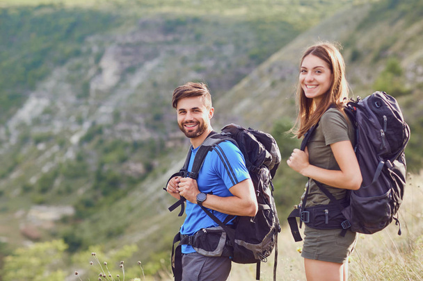 Happy couple of tourists  smiling in nature. - 写真・画像
