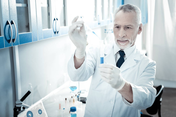 Serious male biologist standing in the lab - 写真・画像
