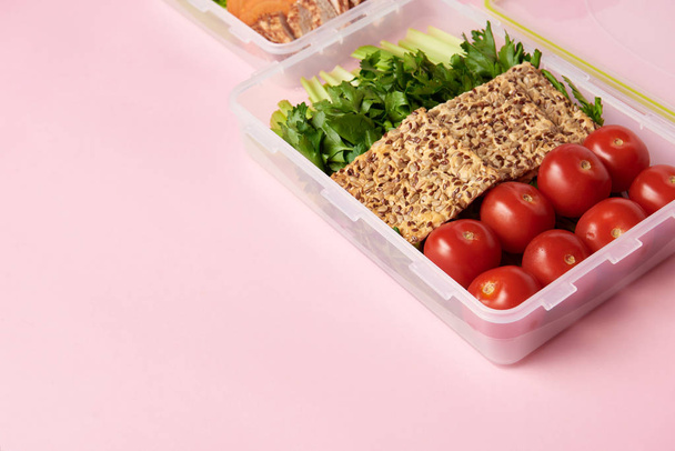 close up view of healthy food arranged in food containers on pink backdrop - Фото, зображення