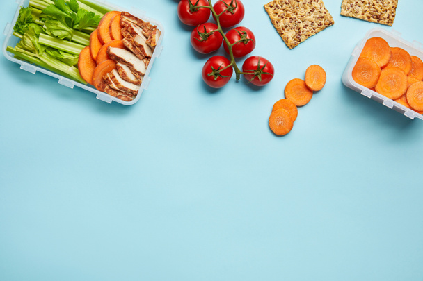 top view of arrangement of food containers with healthy food isolated on blue - Photo, Image