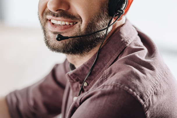 cropped shot of smiling call center worker with microphone - Photo, Image