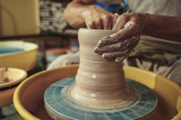 Creating a jar or vase of white clay close-up. Master crock. - Photo, Image
