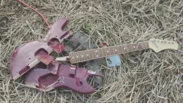 Broken guitar on the grass. Stock. The concept of forgetting classical music - Footage, Video