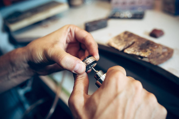 Different goldsmiths tools on the jewelry workplace. Jeweler at work in jewelry. - Фото, зображення