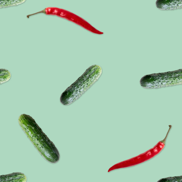 Seamless pattern with cucumber and rd  hot pepper. Vegetables abstract background. Cucumber the white background. - 写真・画像