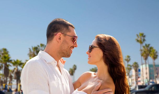 happy couple in sunglasses over venice beach - Fotoğraf, Görsel