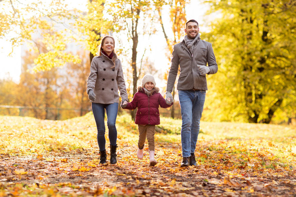 happy family walking at autumn park - Fotografie, Obrázek