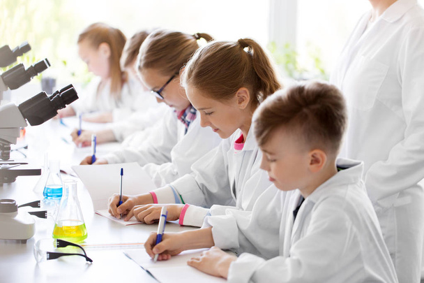 kids studying chemistry at school laboratory - Fotó, kép