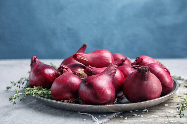Plate with ripe red onions on table - Photo, Image