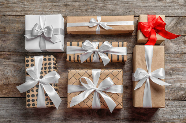 Beautiful gift boxes on wooden background, top view - Foto, Imagem