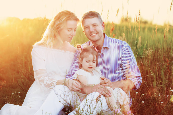 happy family in summer park at sunset - Фото, изображение