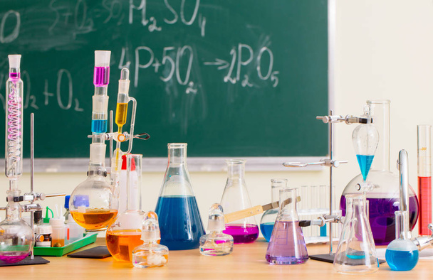 Glass flasks with multi-colored liquids at the chemistry lesson - Φωτογραφία, εικόνα