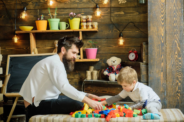 Father concept. Father and son play toy bricks. Father and child building structure model with blocks. My father is my teacher. Fathers day - Zdjęcie, obraz