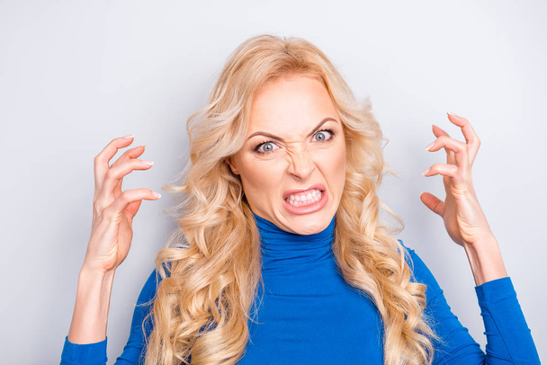 Portrait of sexy, stylish, pretty, cute, charming, nice, angry, nervous, blonde woman in blue roll neck gesturing with hands looking at camera isolated on grey background - Φωτογραφία, εικόνα