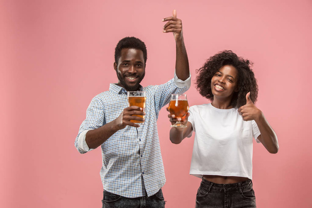 The afro couple or happy young people laughing and drinking beer at studio - Foto, afbeelding