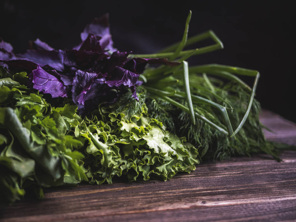 close up mix of herbs on wooden table in dark background - Foto, imagen